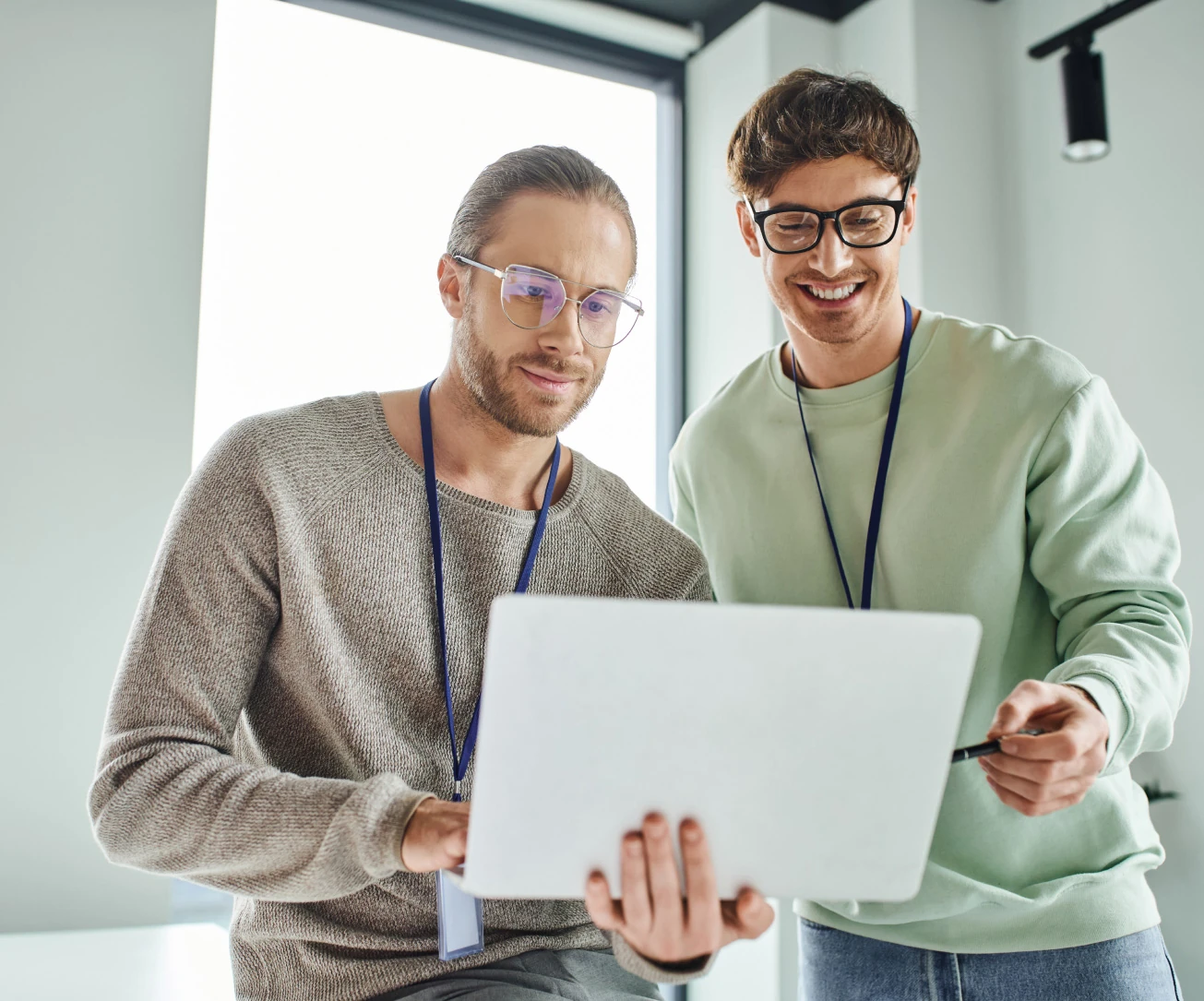 Colleagues confer over a laptop